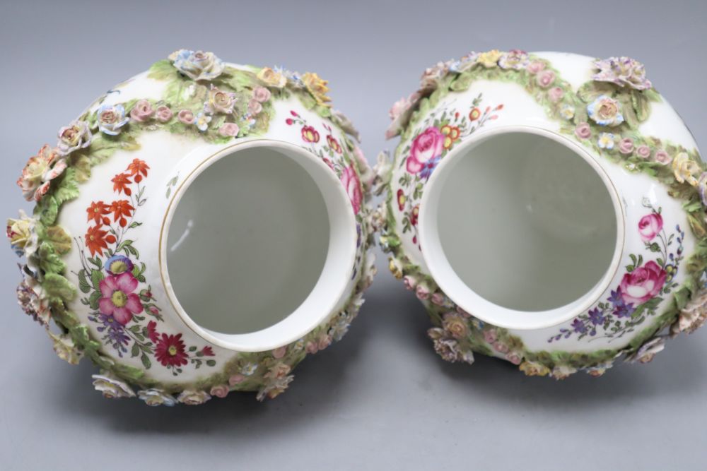 A pair of Augustus Rex floral encrusted porcelain vases and covers and a similar putti centrepiece, tallest 37cm